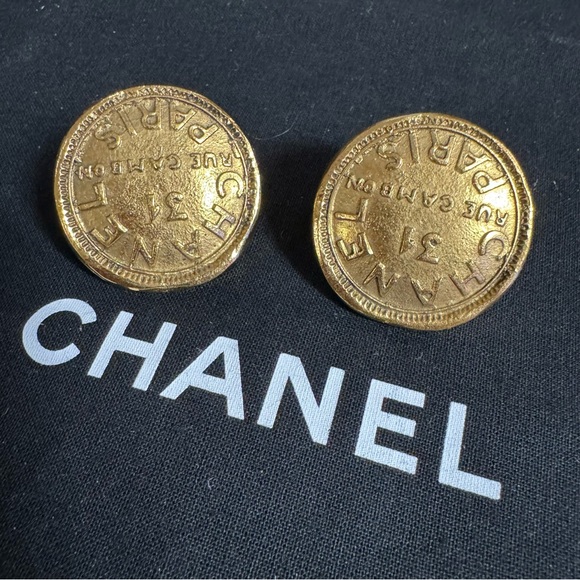 Authentic CHANELgold toned medallion clip on earrings